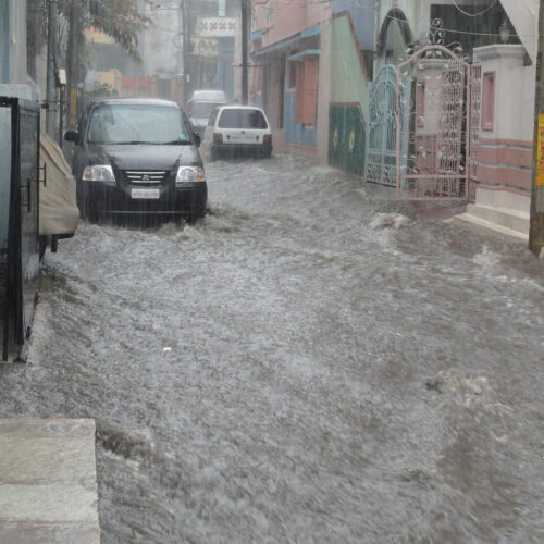 Image of a flooding street with cars