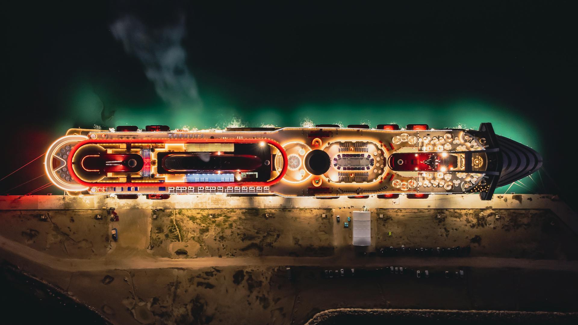 image of cruise ship at the sea at night with lights drone view