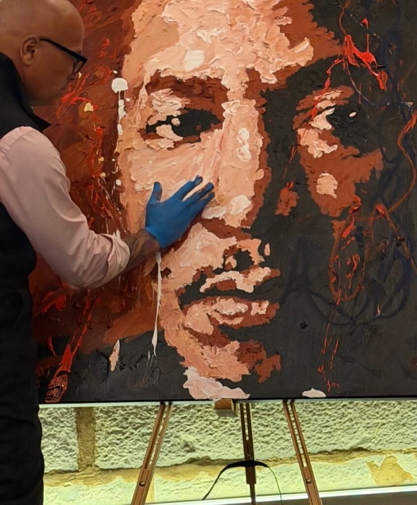 Ramaya Vallias painting "Presence that Echoes - MLK" during the Ceremony of Civil Diplomat Jethro International Org.